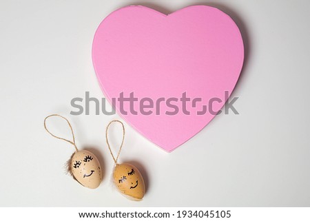 Beautiful composition of pussy willow and eggs with a drawn cute face and heart ER