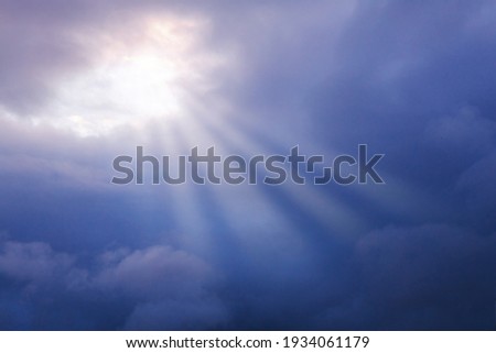storm clouds, dark blue clouds, rays of the sun through the skylight, the concept of hope, faith, resurrection Royalty-Free Stock Photo #1934061179