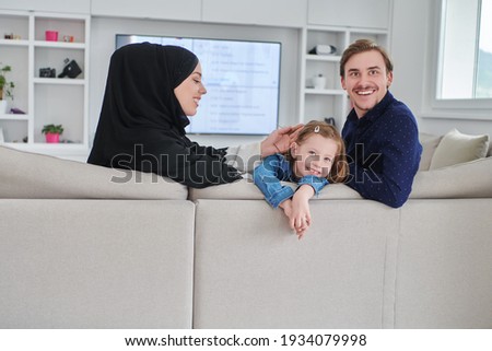 Happy Muslim family spending time together in modern home