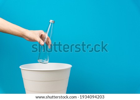 The glass bottle is thrown for recycling. For disposal in the trash can, bottom view. Royalty-Free Stock Photo #1934094203