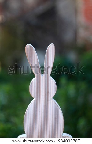 Wooden bunny silhouette, minimal Easter decoration. Selective focus.