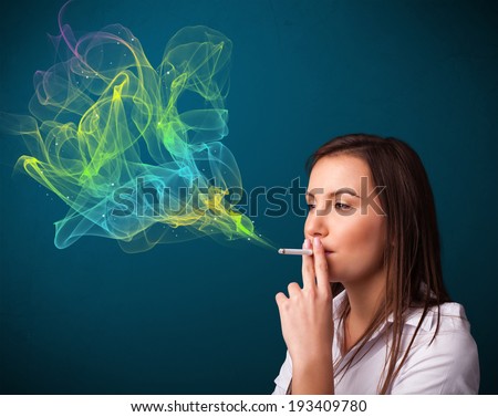 Pretty young lady smoking cigarette with colorful smoke