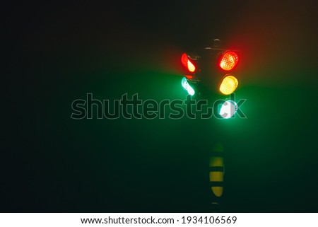 traffic lights at night in dense fog