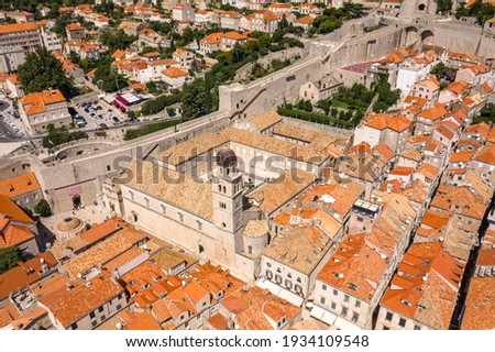 Aerial drone shot of bell tower coupola of Franciscan church on Stradun street in Dubrovnik old town in Croatia summer