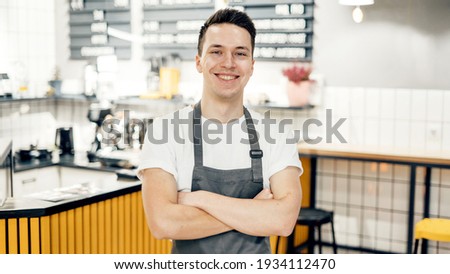 A small coffee business. The salesman is a uniformed employee. Works in a restaurant as a salesman. Favorite job in the restaurant industry. Royalty-Free Stock Photo #1934112470