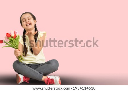 Picture of litlle girl with tulips in hands