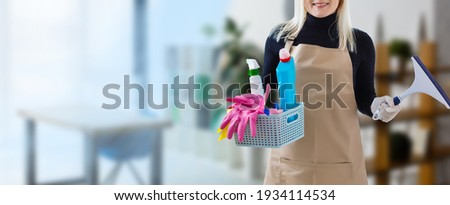 Young smiling cleaner woman in modern house Royalty-Free Stock Photo #1934114534