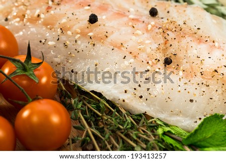 Fillet of fresh raw fish with herbs and spices 