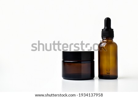 Brown vessels for cosmetics on a white background.