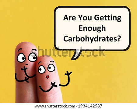 Two fingers are decorated as two person. One of them is asking  another if he is getting enough carbohydrates. 