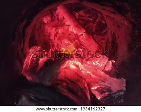 Red colored burning firewood cave on fireplace stunning hot looking flame 