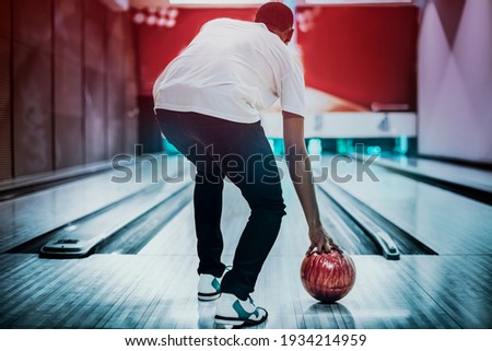 African American bowling at a hall