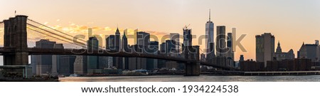 Manhattan Skyscrapers and Brooklyn bridge at dusk in New York, USA