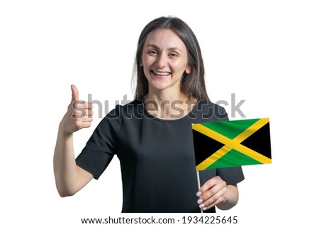 Happy young white woman holding flag of Jamaica and shows the class by hand isolated on a white background.