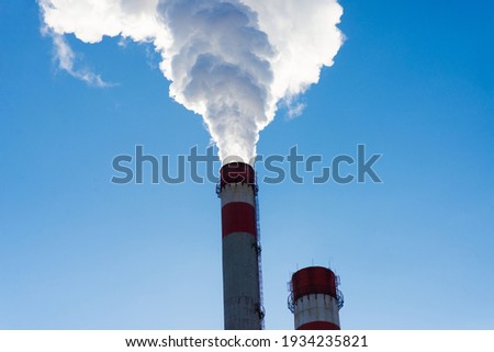 Industrial landscape, cranes, pipes with smoke. Air pollution from smokestacks, ecological problems concept Royalty-Free Stock Photo #1934235821