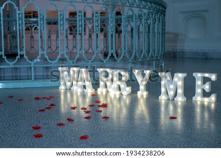 Rose petals and "Marry Me" message board