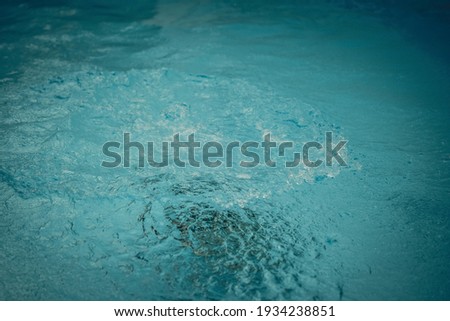 Abstract photo lifestyle background. Unrecognizable person deep under water. Mystery mood. Concept of weightless, uncertain future, drown in obscurity. Wave droplets bubbles on liquid surface