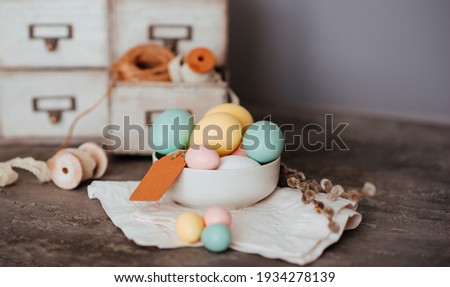 Easter eggs on wooden background. Vintage spring background for spring holidays. Easter composition with colorful Easter eggs and spring flowers.
