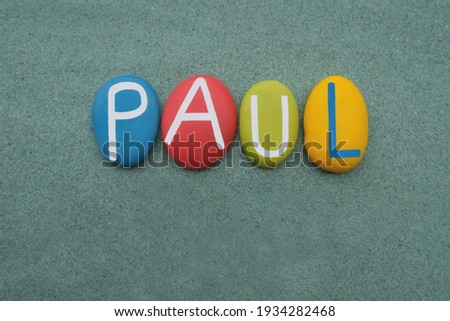 Paul, male given name composed with multi colored stone letters over green sand Royalty-Free Stock Photo #1934282468