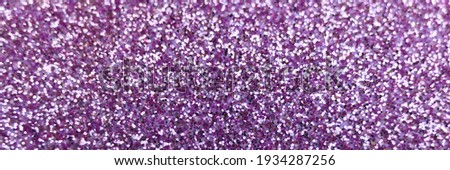 blurred purple glitter background close up. defocused. banner