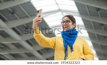 Happy caucasian woman is walking and talking on video communication on the phone