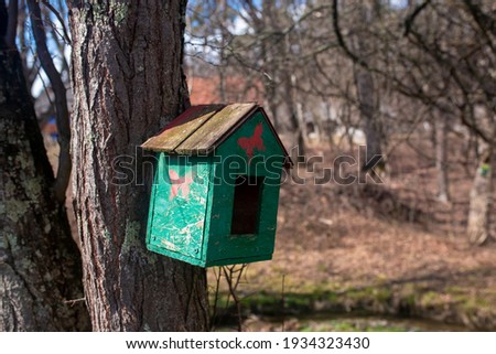 Handcrafted house bird on old tree