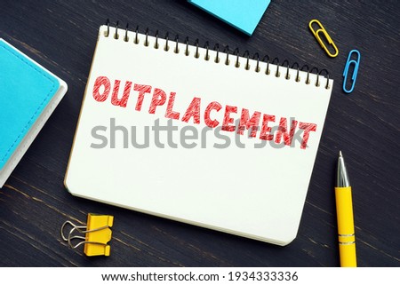 Financial concept meaning OUTPLACEMENT with sign on the sheet. OutplacementÂ is any service that assists a departing employee with obtaining a new job or transitioning to a new career
