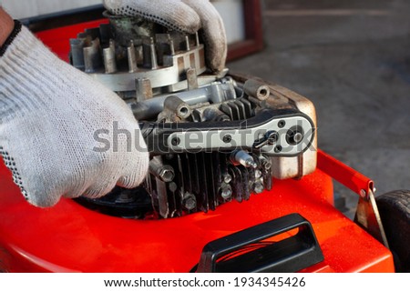 Torque wrench, mower repair - profesional service. Royalty-Free Stock Photo #1934345426