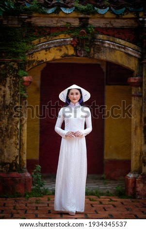 Ho Chi Minh City, Vietnam: Portrait women in white ao dai Vietnam, The Ao dai ( long-dress Vietnamese) is traditional costume of Vietnamese woman Royalty-Free Stock Photo #1934345537