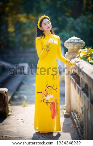 Ho Chi Minh City, Vietnam: Portrait women in yellow ao dai Vietnam, The Ao dai ( long-dress Vietnamese) is traditional costume of Vietnamese woman Royalty-Free Stock Photo #1934348939
