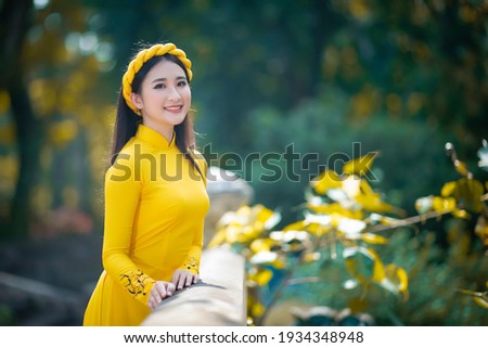 Ho Chi Minh City, Vietnam: Portrait women in yellow ao dai Vietnam, The Ao dai ( long-dress Vietnamese) is traditional costume of Vietnamese woman Royalty-Free Stock Photo #1934348948