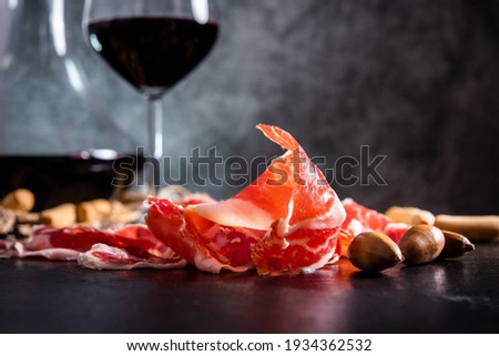 Iberian Ham. acorn-fed Iberian ham. Iberian ham with a glass of wine Royalty-Free Stock Photo #1934362532