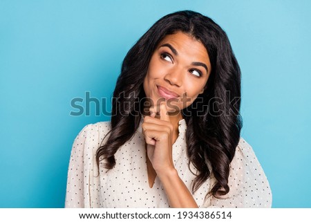 Photo of young happy positive smiling thoughtful minded afro girl look copyspace thinking isolated on blue color background