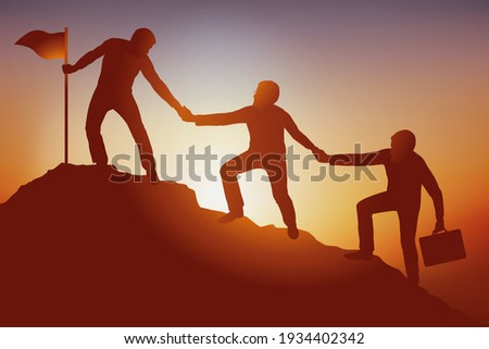 Symbol of teamwork in business with a group that helps each other to climb a mountain and achieve their goal. Royalty-Free Stock Photo #1934402342