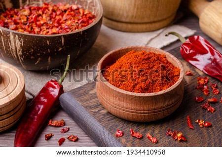 Red dried pepper on a dark wooden background. Selective focus. Royalty-Free Stock Photo #1934410958