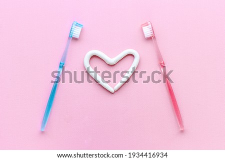 Teeth hygiene. Toothbrush with heart shape made of toothpaste, top view