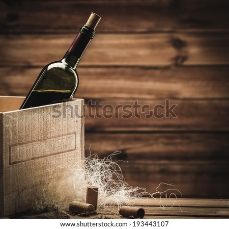 Bottle of wine in box in wooden interior 