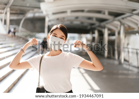 Happy young adult business asian woman wear face mask for protect virus corona or covid19 and air pollution. Urban people lifestyle with public health on day concept. Royalty-Free Stock Photo #1934467091