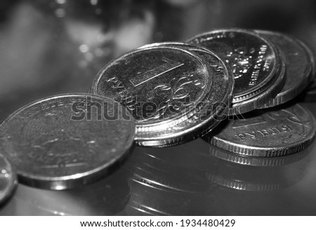 coins lie in a pile on the glass. Close up photo