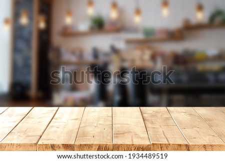 Abstract blurred background of empty wooden table and blurred coffee shop background, product display. Royalty-Free Stock Photo #1934489519