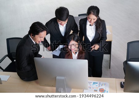 Group of Asian staff working on night shift in customer service center, selective focus                               