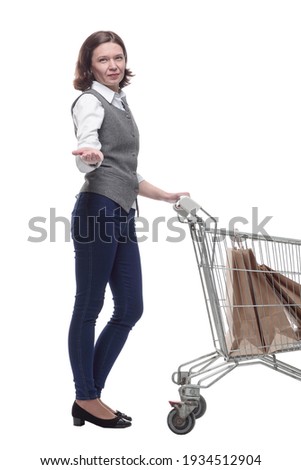 casual mature woman with shopping cart . isolated on a white