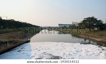 the river is polluted by detergent waste