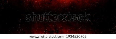 Fire embers particles over black background. Fire sparks background. Abstract dark glitter fire particles lights. bonfire in motion blur. Royalty-Free Stock Photo #1934520908