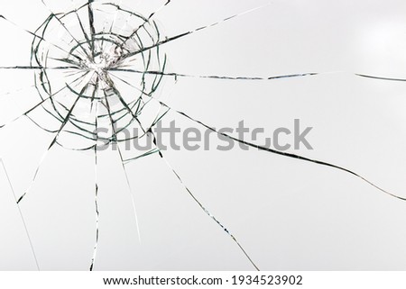 Cracks on the glass on a white background. Broken window. Royalty-Free Stock Photo #1934523902