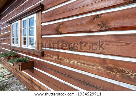 Traditional old wooden cottage in winter. High quality photo.