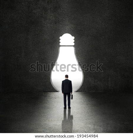Light bulb before the businessman - idea concept
