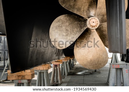 Close up detail of the propeller of a superyacht hauled out in shipyard for maintenance work Royalty-Free Stock Photo #1934569430