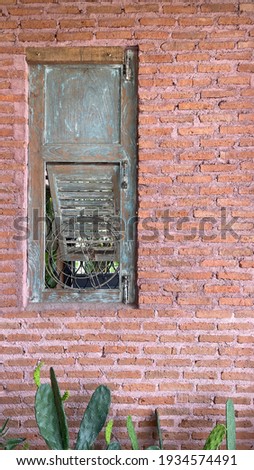 Sideview of window with red brick wall