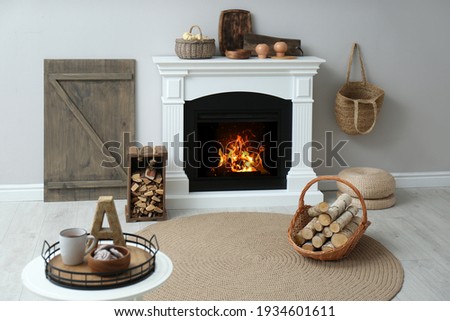Cozy living room interior with firewood and white fireplace